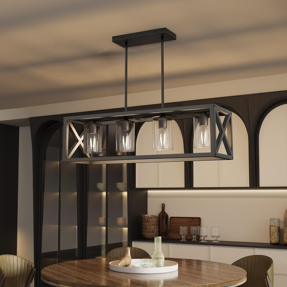 Rectangular metal chandelier with four glass shades hanging over a round wood dining table.
