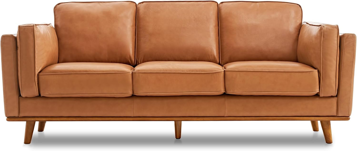 Front-facing isolated cognac leather three-seat sofa on white background with tapered wooden legs