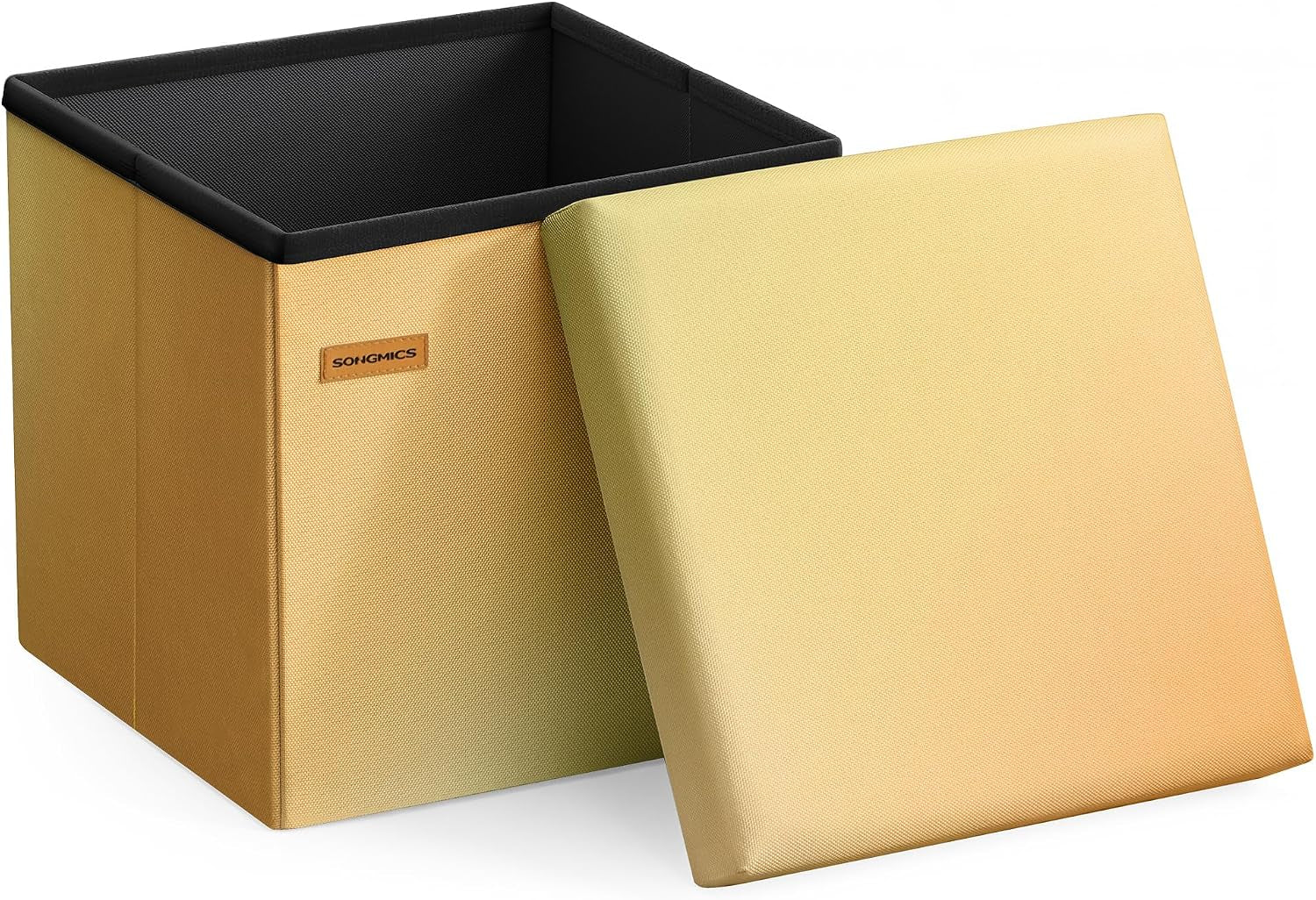 Square foldable storage ottoman with lid leaned forward; warm yellow-to-gold gradient fabric exterior and black interior.