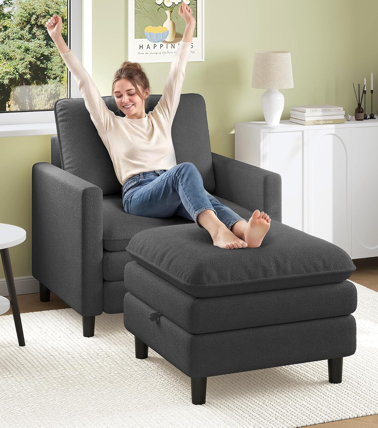 Charcoal armchair with matching ottoman and a woman stretching with feet on the ottoman