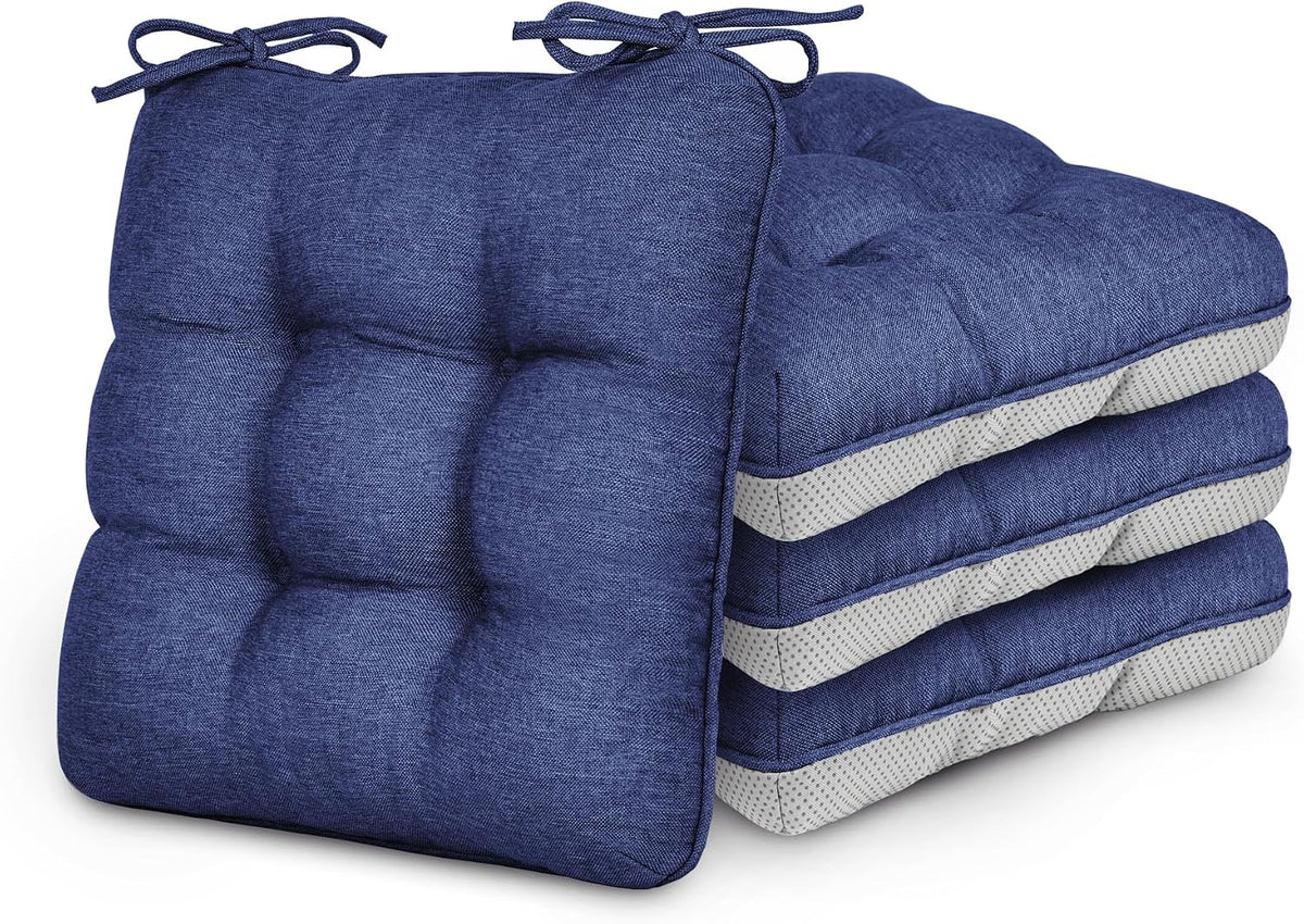 Stack of four navy blue tufted chair cushions with ties, one cushion propped in front