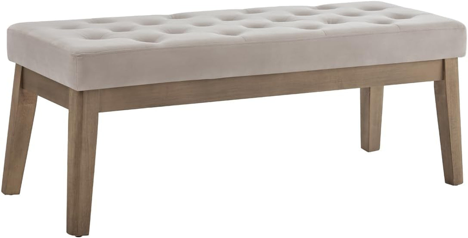 Light taupe tufted bench with visible solid wood base and legs on a plain white background