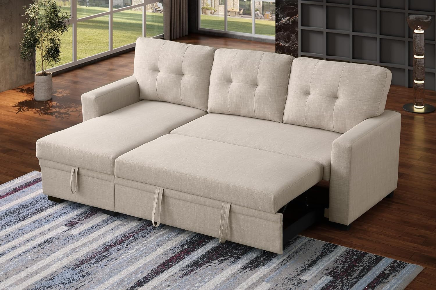 Front-facing view of beige L-shaped sectional pulled into a bed with three tufted back cushions and visible pull straps.