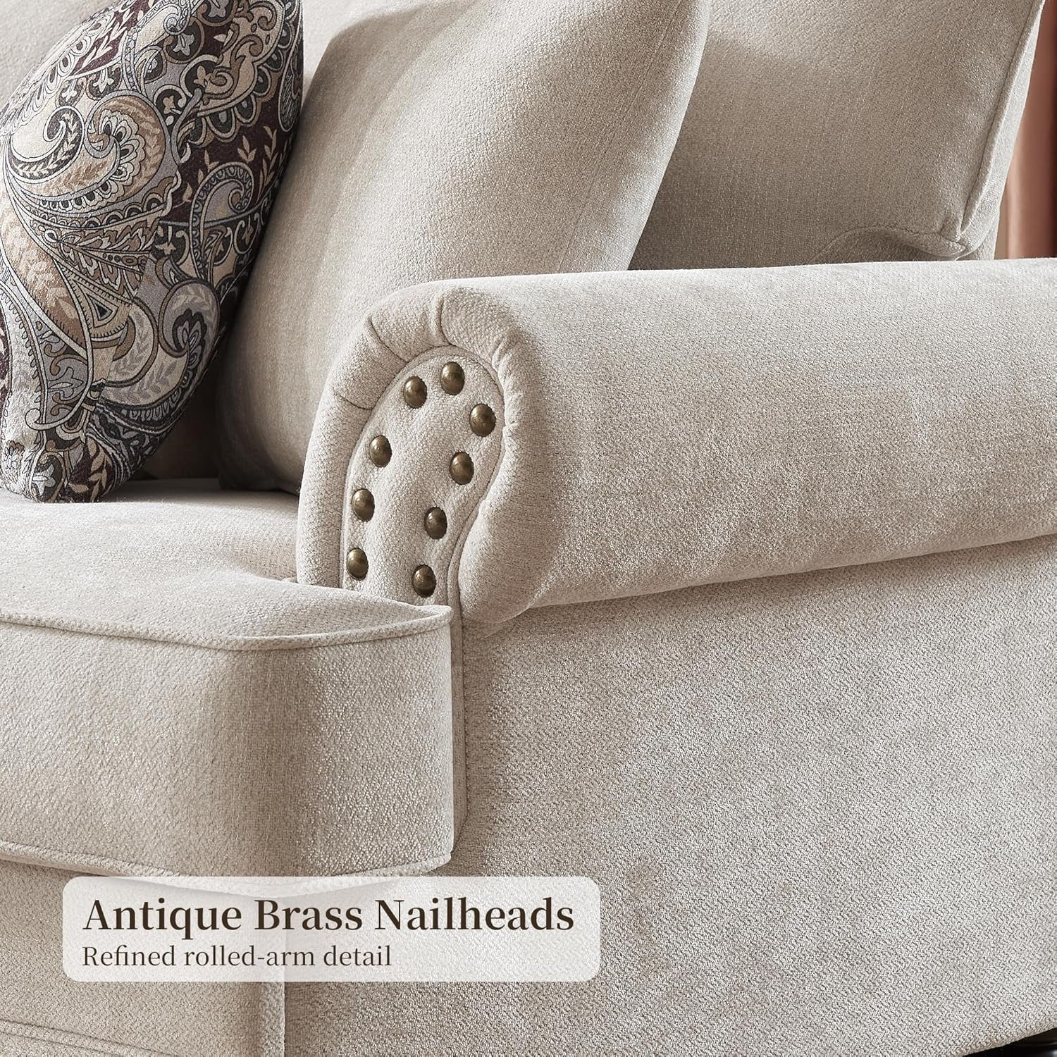 Detail of rolled arm with antique brass nailhead trim and textured chenille upholstery