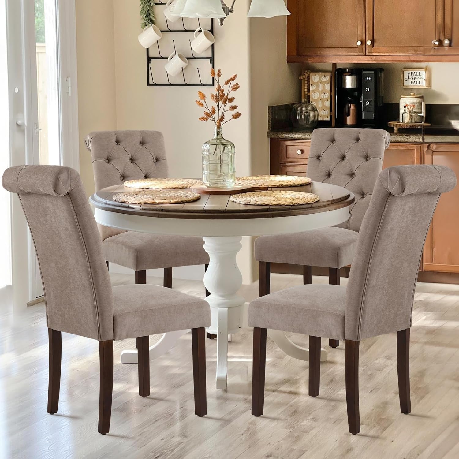 Set of four taupe Parsons dining chairs around a round table in a bright kitchen setting
