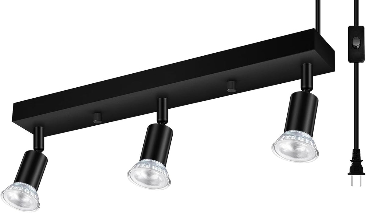 Angled view of a black three-head ceiling track light with GU10 bulbs installed and plug cord at the side.
