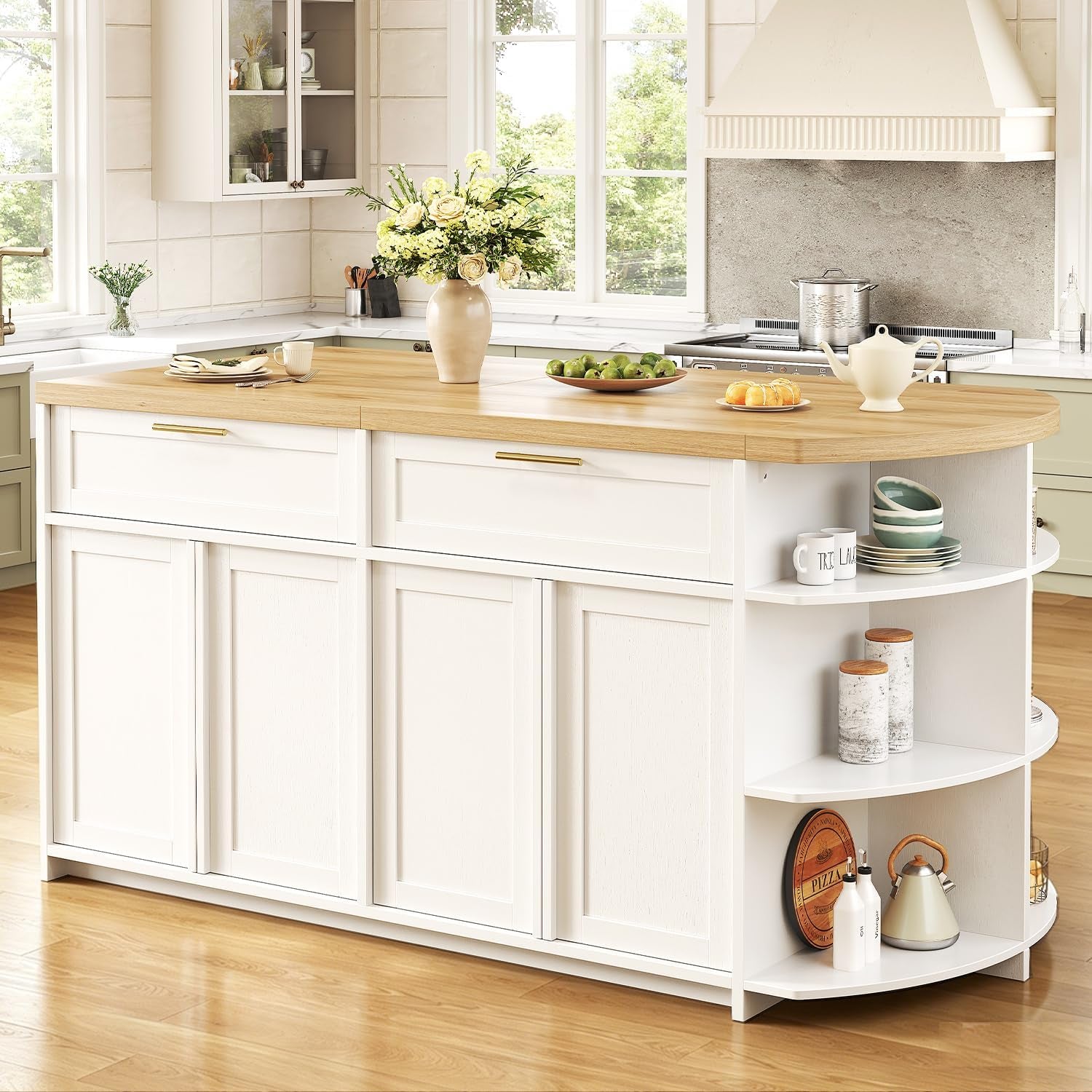 Right-side view of a white kitchen island with rounded open shelves, light wood top and decorative tableware