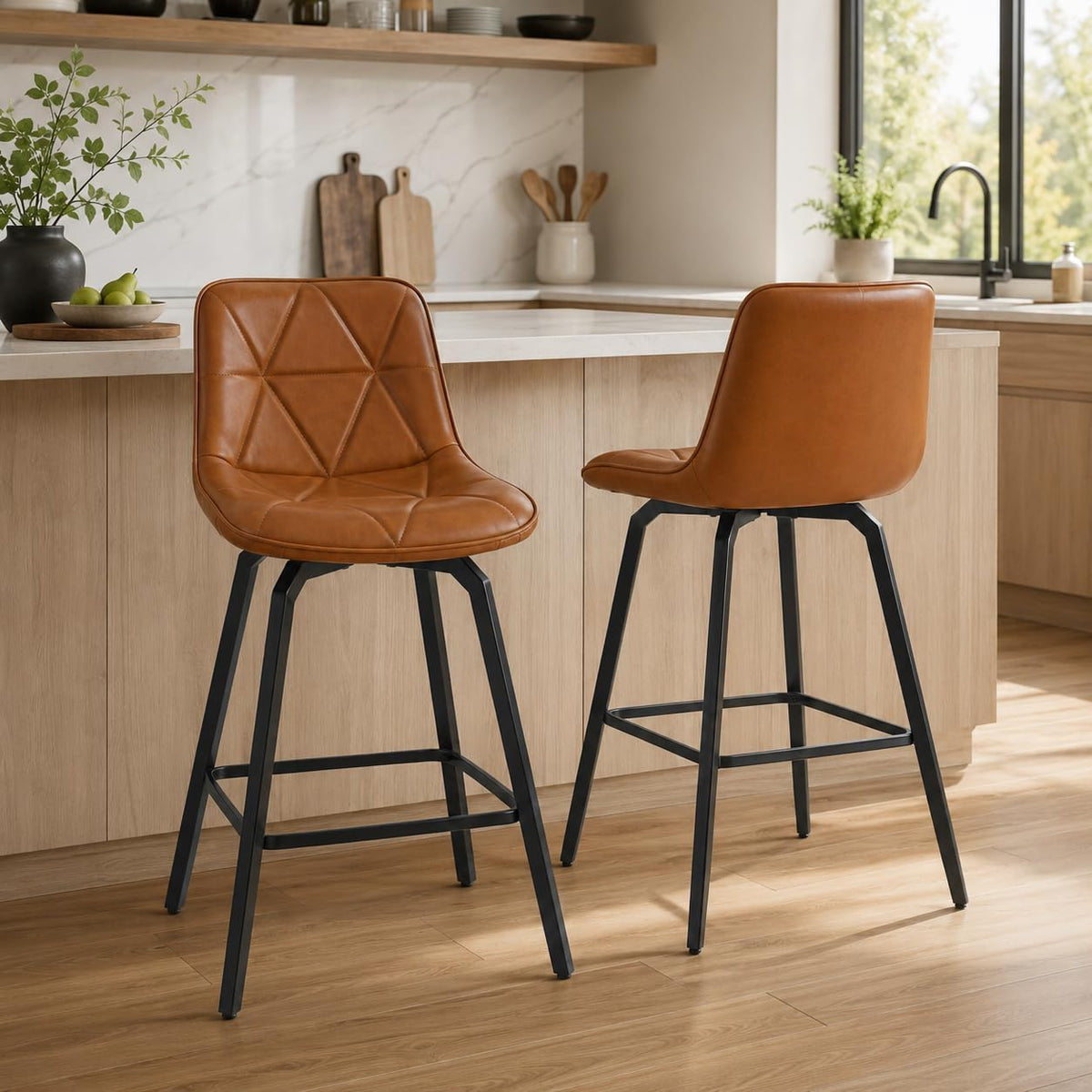 Two cognac-brown faux-leather counter stools with stitched triangular pattern at a kitchen island