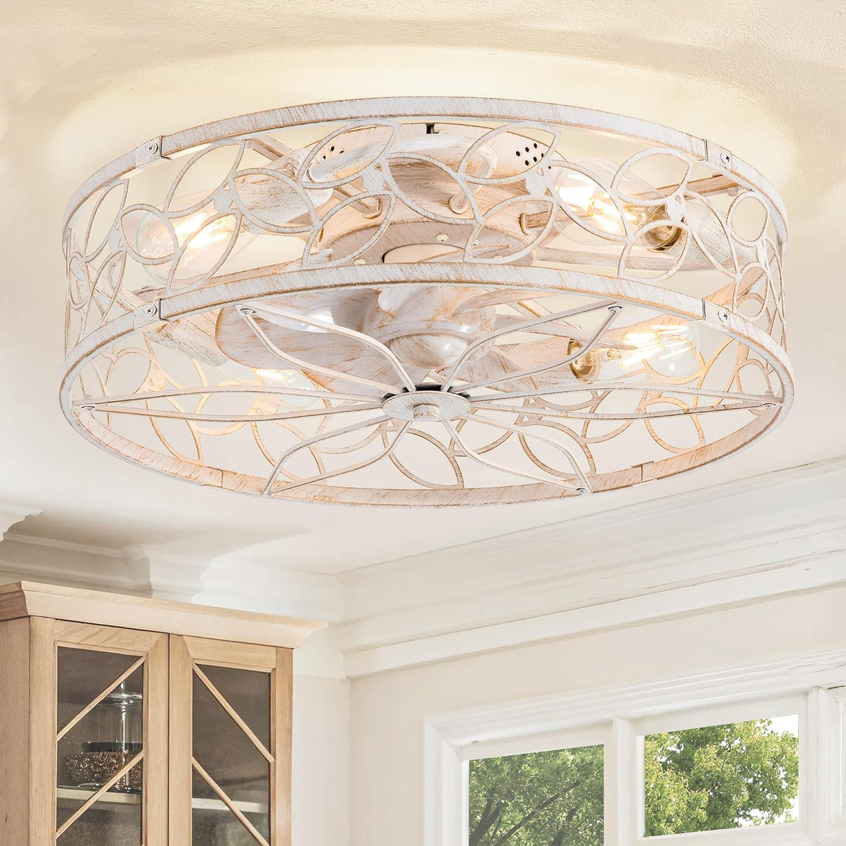 Flush-mount cage-style ceiling fixture in a whitewashed finish installed above kitchen cabinets.