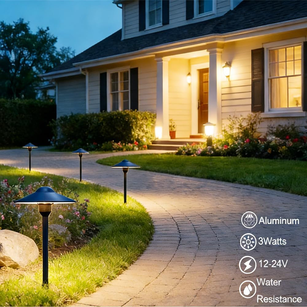 Multiple black pathway lights lining a curved brick walkway at dusk with warm-white illumination