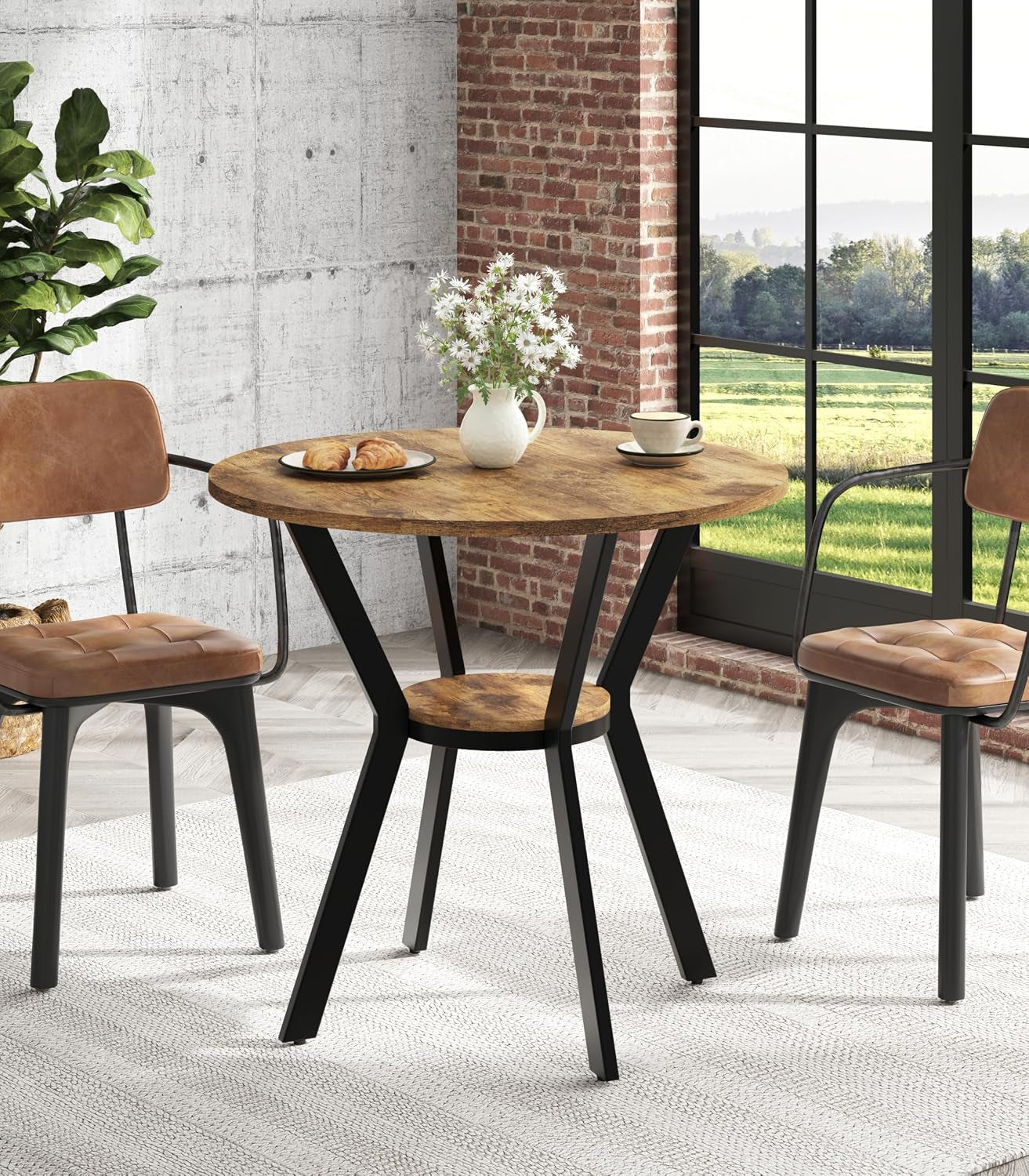 Round wood table with black angled legs and small lower shelf set by window with two chairs