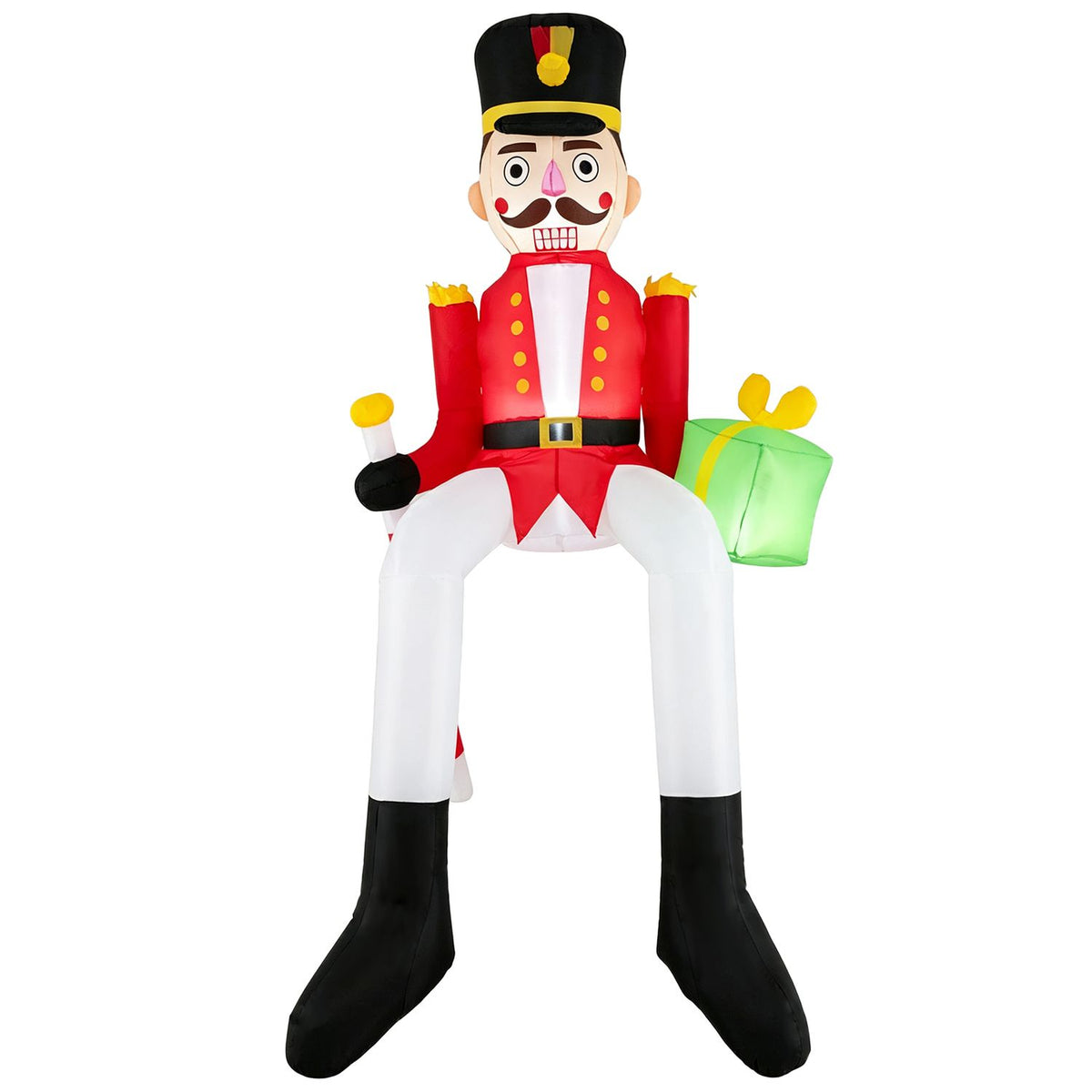 A seated nutcracker inflatable wears a red jacket, white trousers, black boots, and a tall black hat.