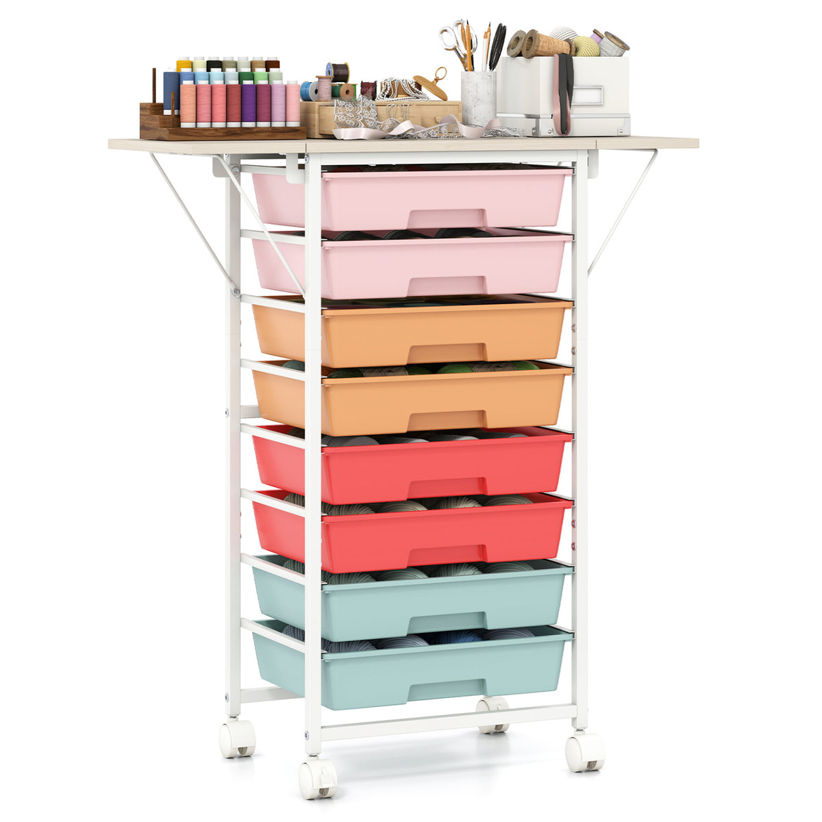 White rolling cart with colorful drawers and an extended tabletop holding sewing supplies.