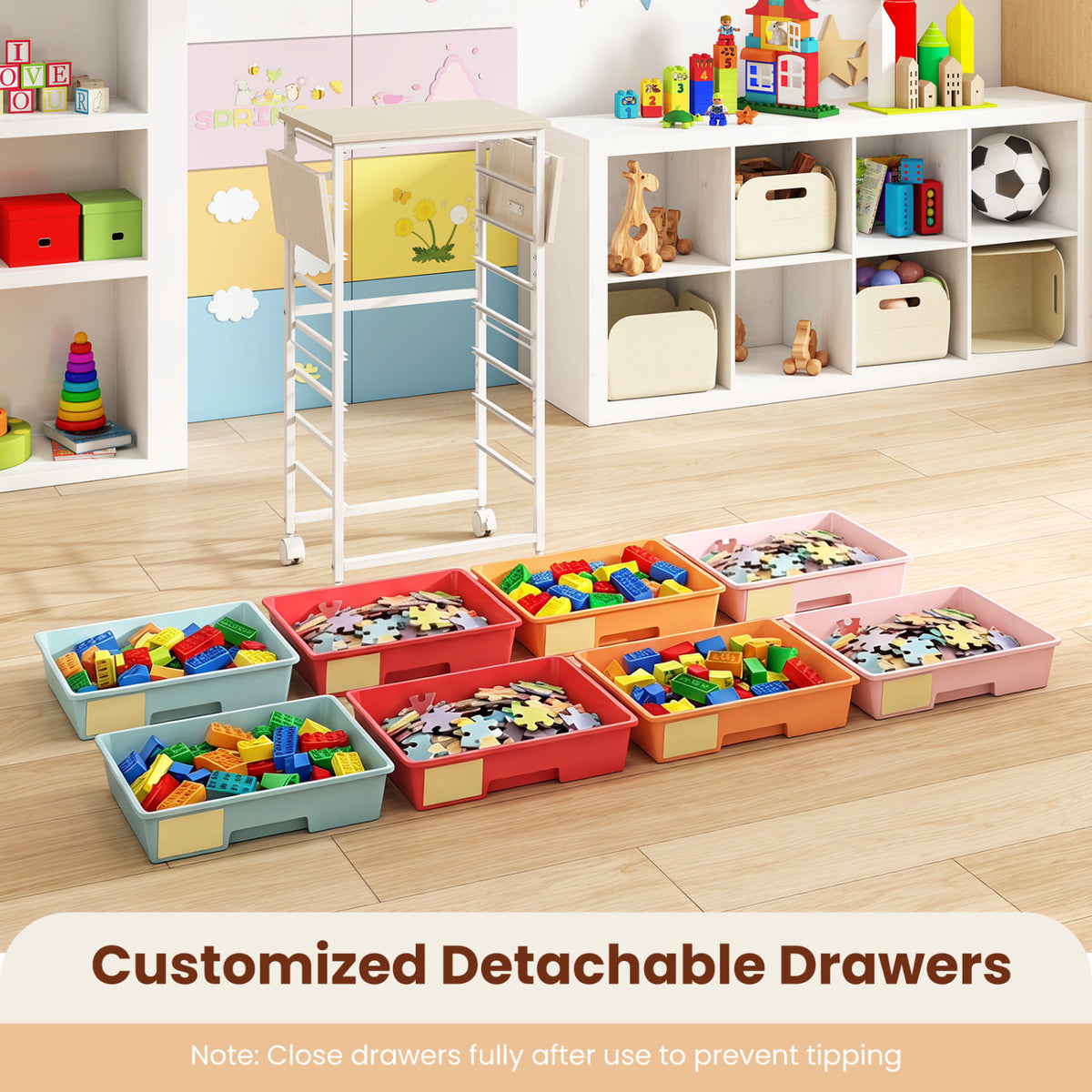 Colorful removable drawers filled with toys and craft pieces arranged on a playroom floor beside the cart.