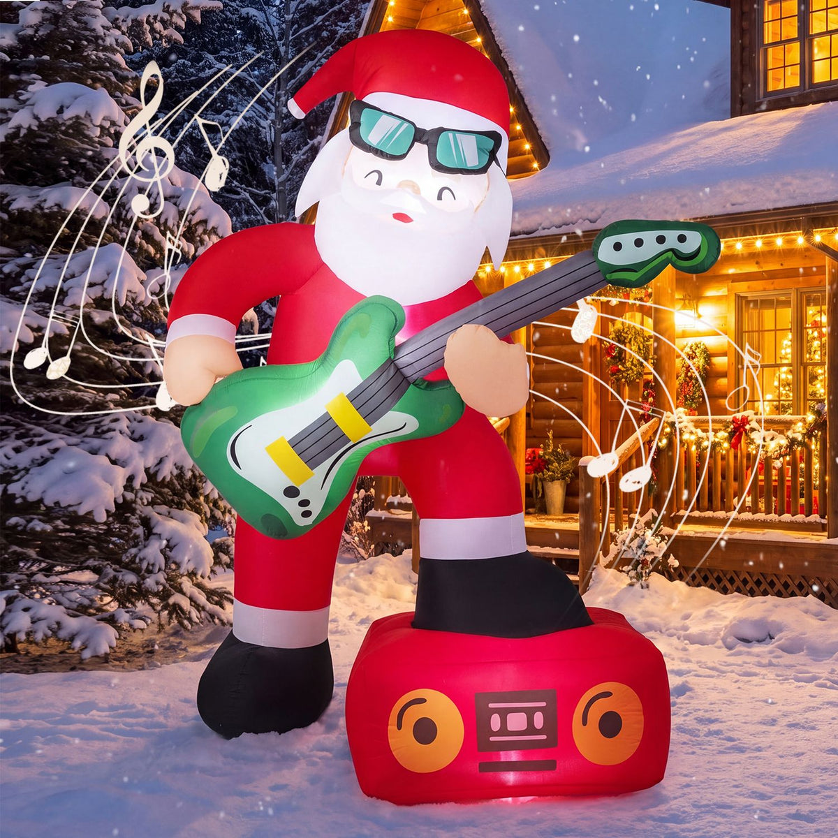 Inflatable Santa in sunglasses plays a green guitar in a snowy yard beside a warmly lit house.