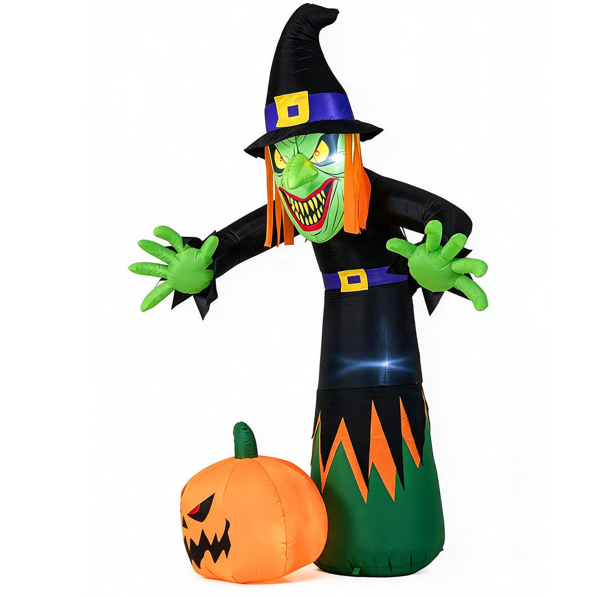 Angled view of the inflatable witch reaching forward beside a large orange pumpkin on white.