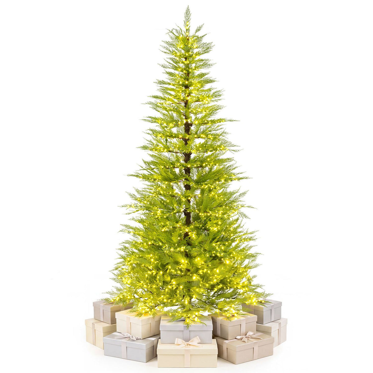 A lit artificial Christmas tree stands against white, with pale wrapped gifts around its base.