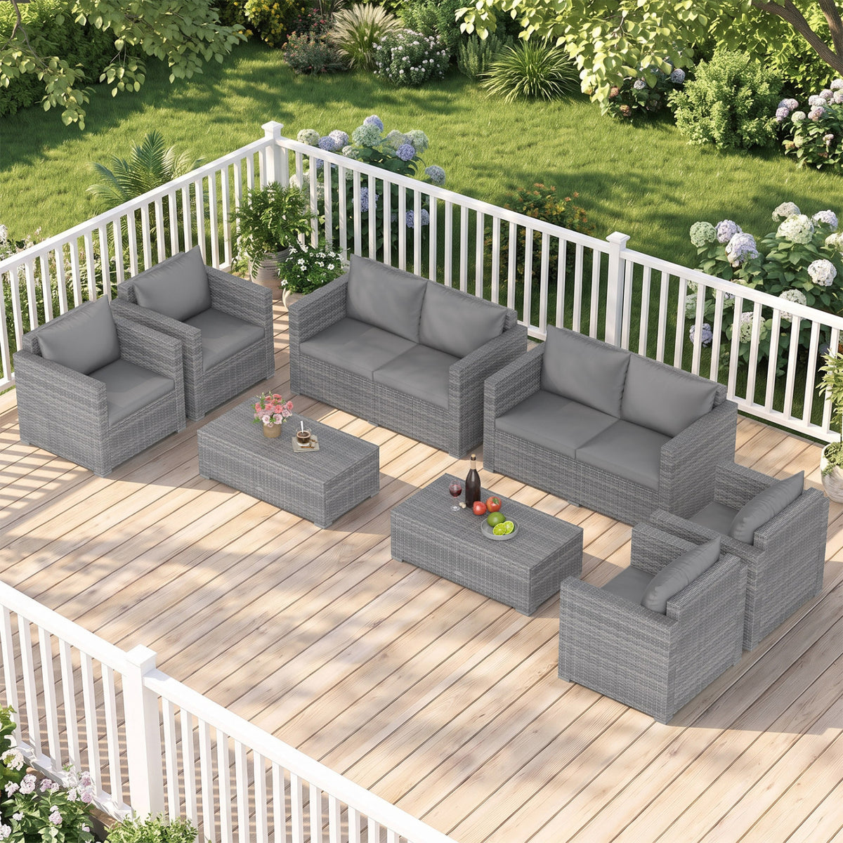 Gray rattan conversation set with two loveseats, four chairs and coffee tables on a deck