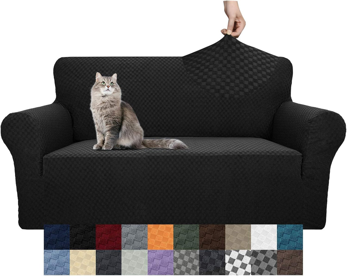 Black textured sofa cover on a three-cushion couch with a cat on the seat and a hand pulling the back fabric