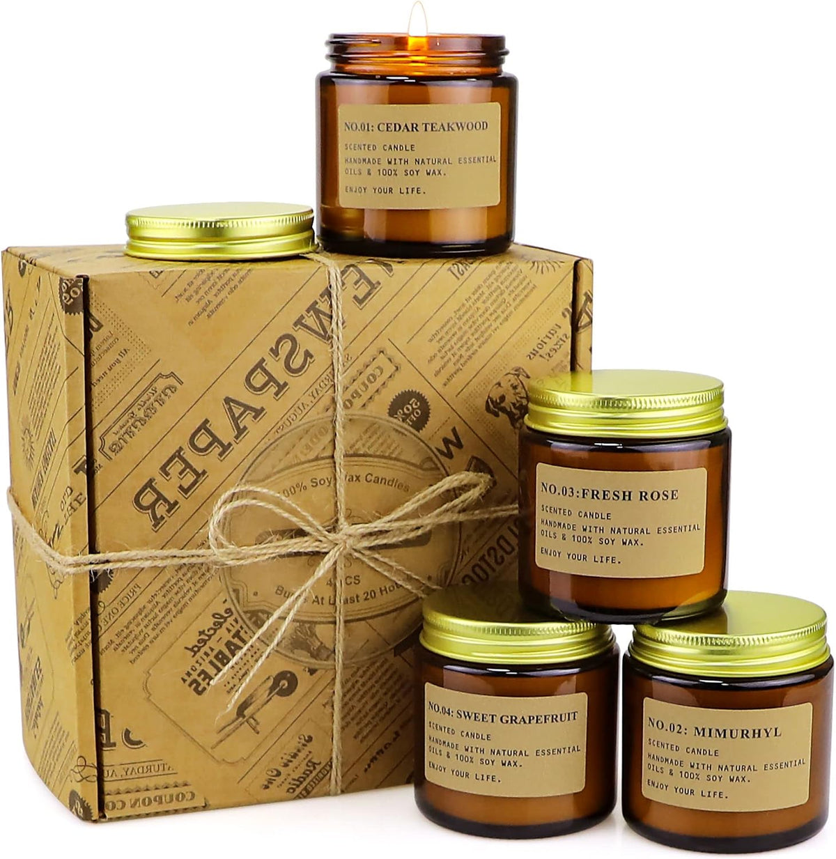 Three amber glass jars stacked beside a patterned kraft gift box tied with twine and two metal lids.