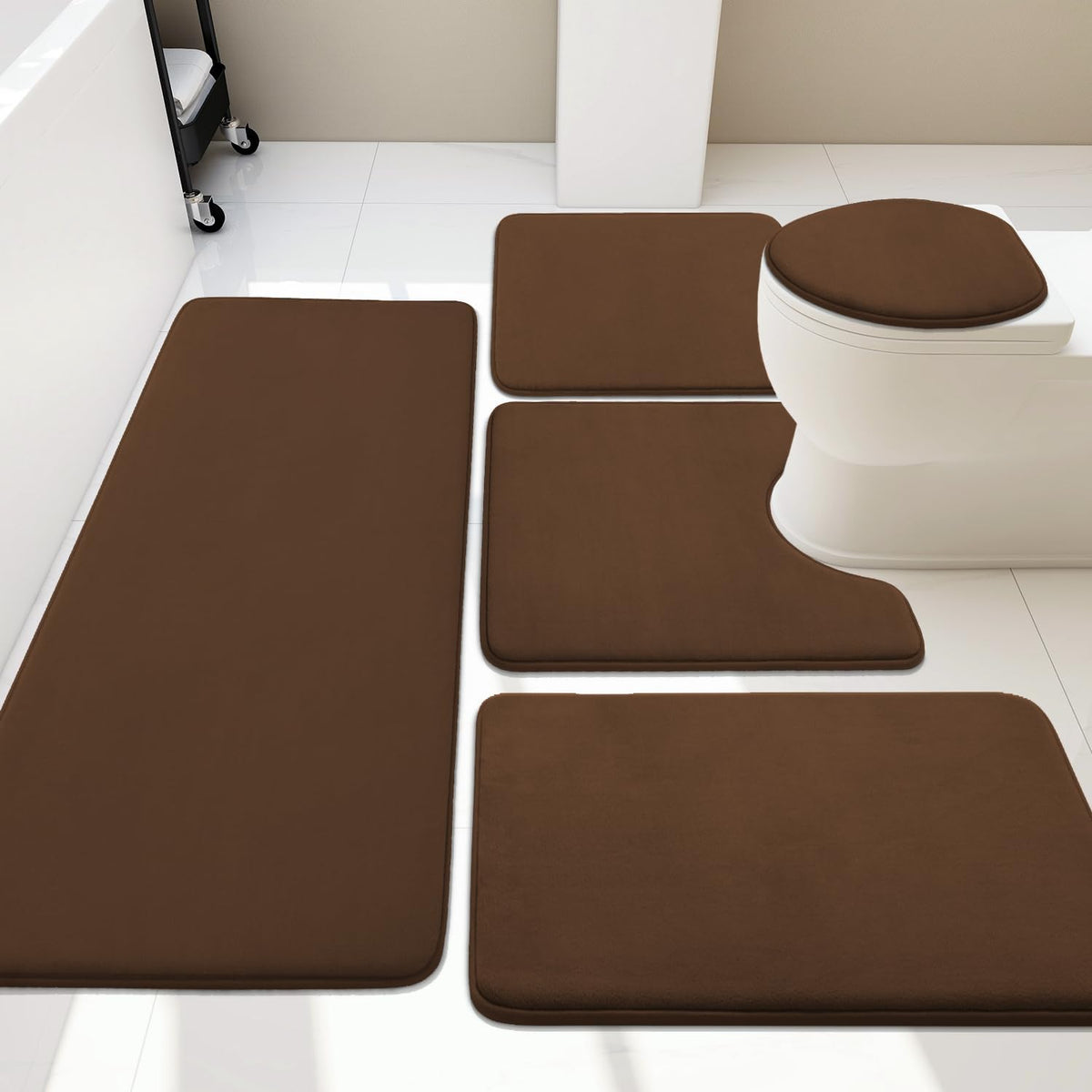 Arranged set of five brown bathroom mats including U-shaped and rectangular pieces around a toilet.