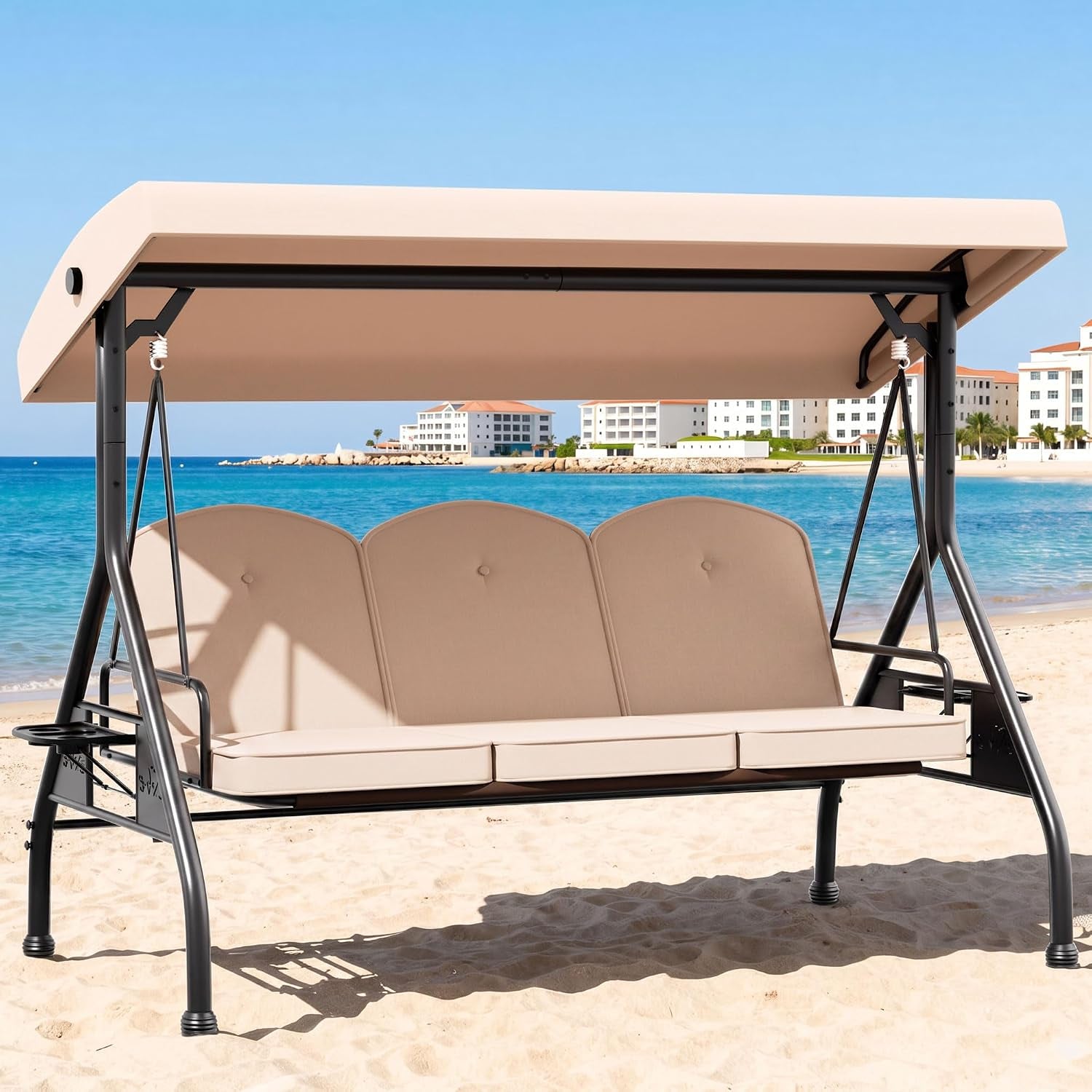 Three-seat outdoor swing with tan cushions and adjustable canopy set on a sandy beach.