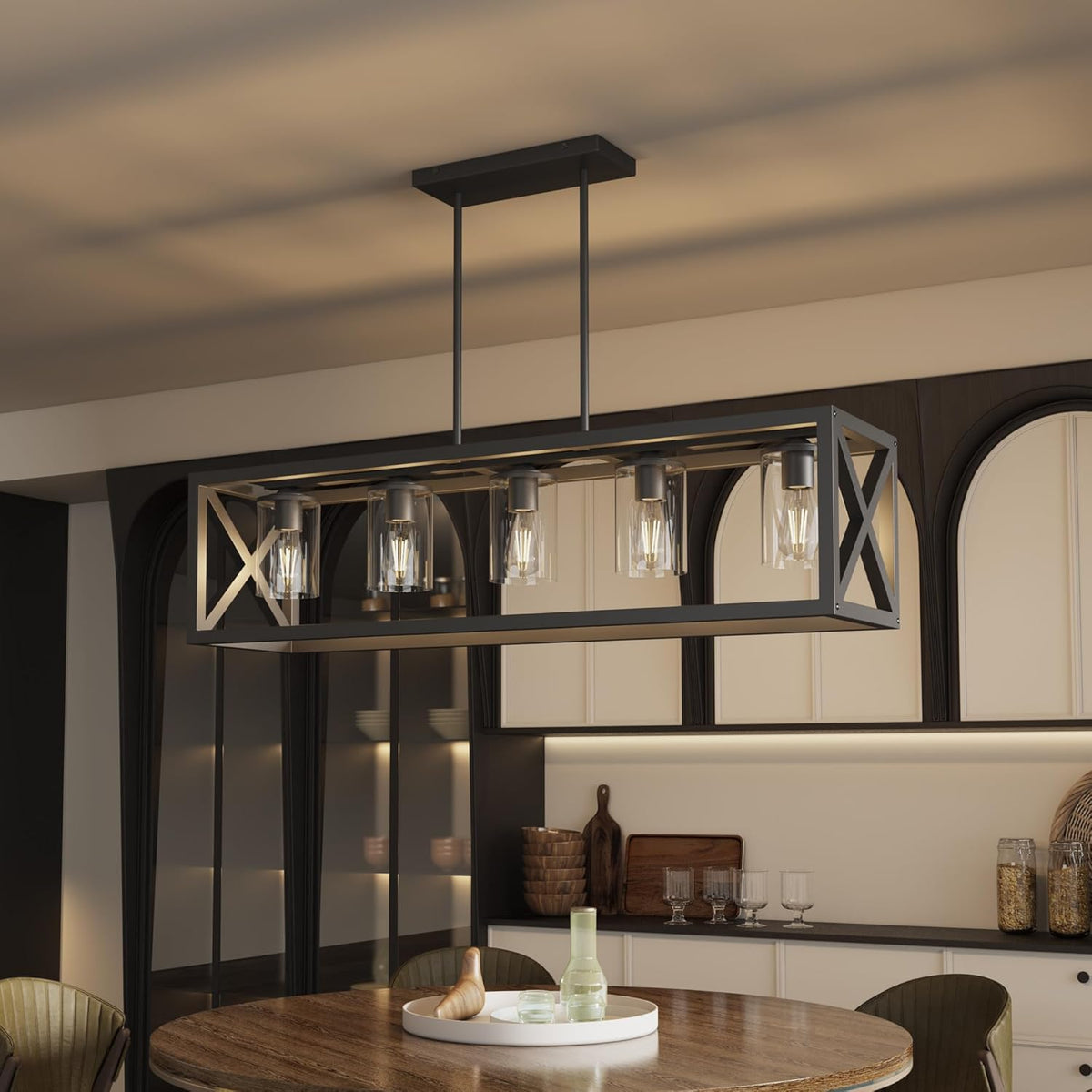 Close detail of the chandelier frame with X-brace ends and five lit glass shades suspended from two rods.