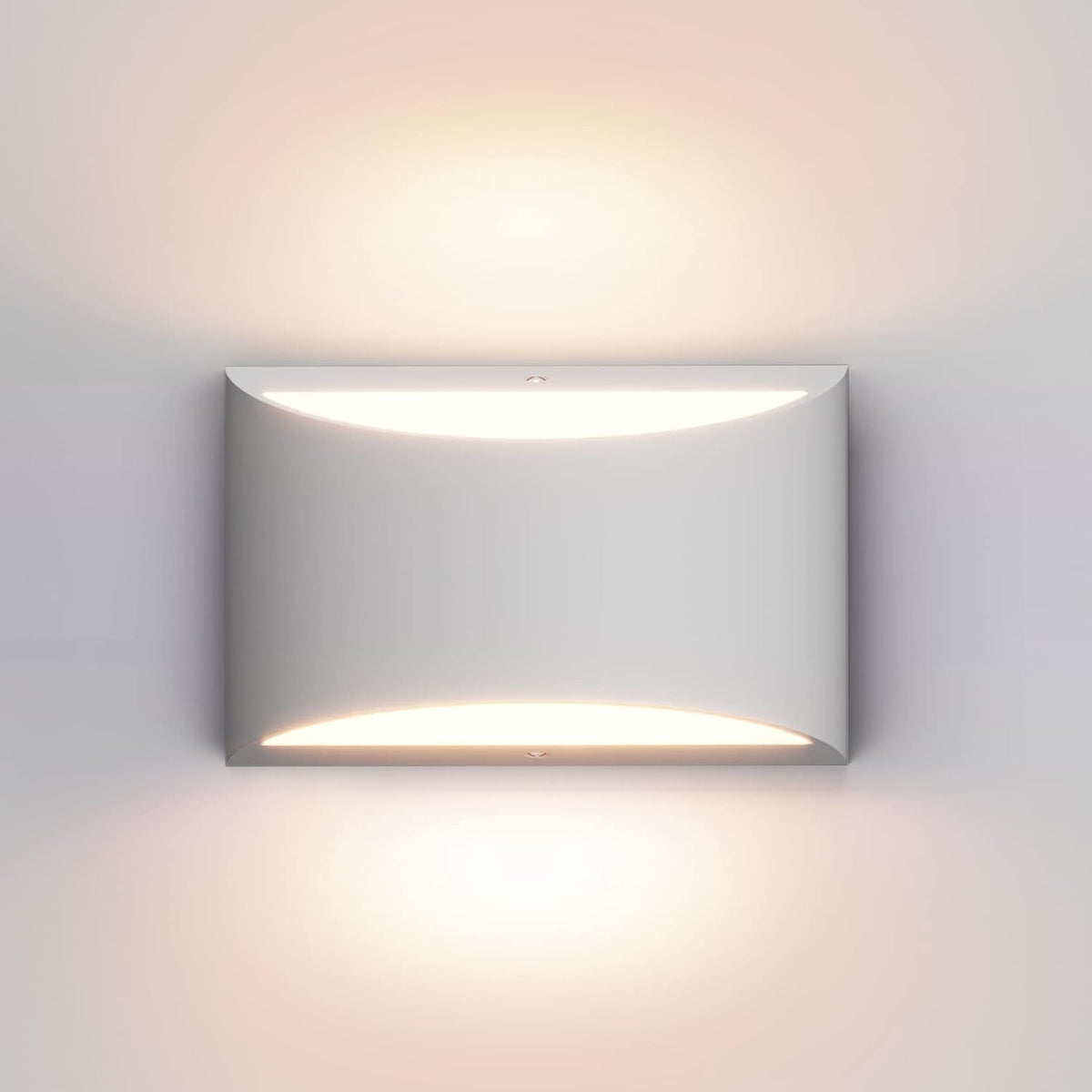Close-up front view of a single white wall sconce casting warm up-and-down light.