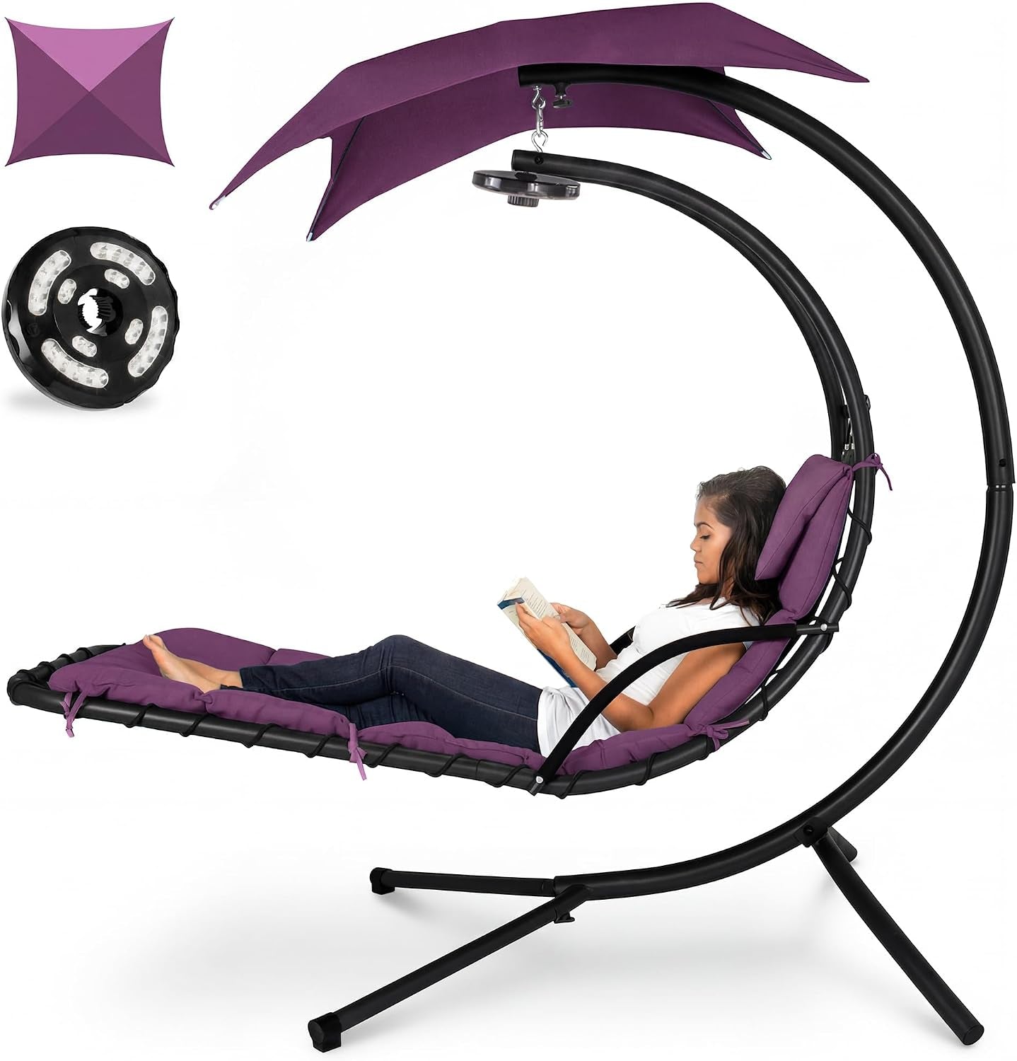 Same curved hanging chaise shown in deep purple with matching cushions and canopy, woman reading.