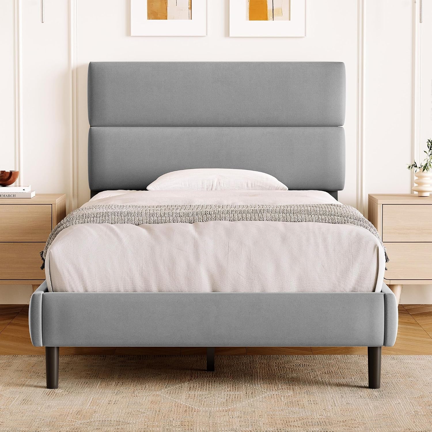 Front bedroom view of a compact gray upholstered bed with a tall two-panel headboard.