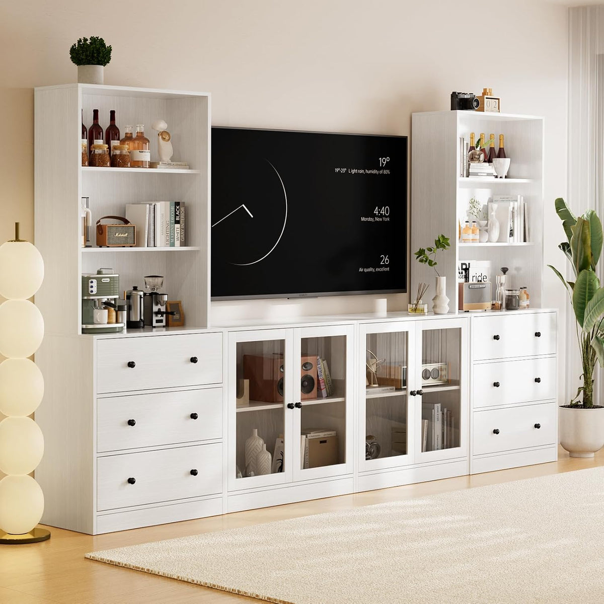 Closer crop of the white modular units focusing on glass-front center cabinets, drawers and shelving.