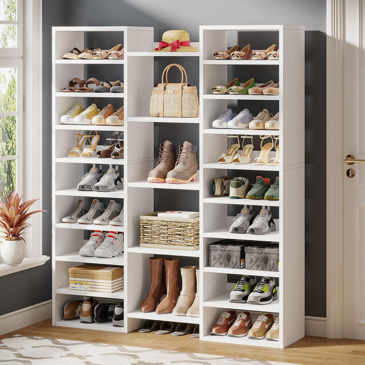 White 14-tier three-column shoe rack angled front view with shoes and accessories in an entryway
