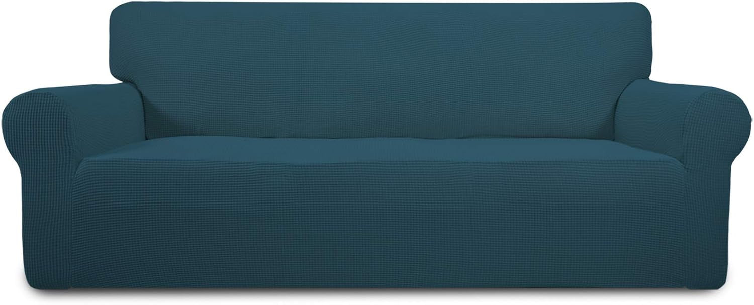 Front-facing loveseat dressed in a deep teal stretch slipcover, shown neatly fitted over cushions and arms.