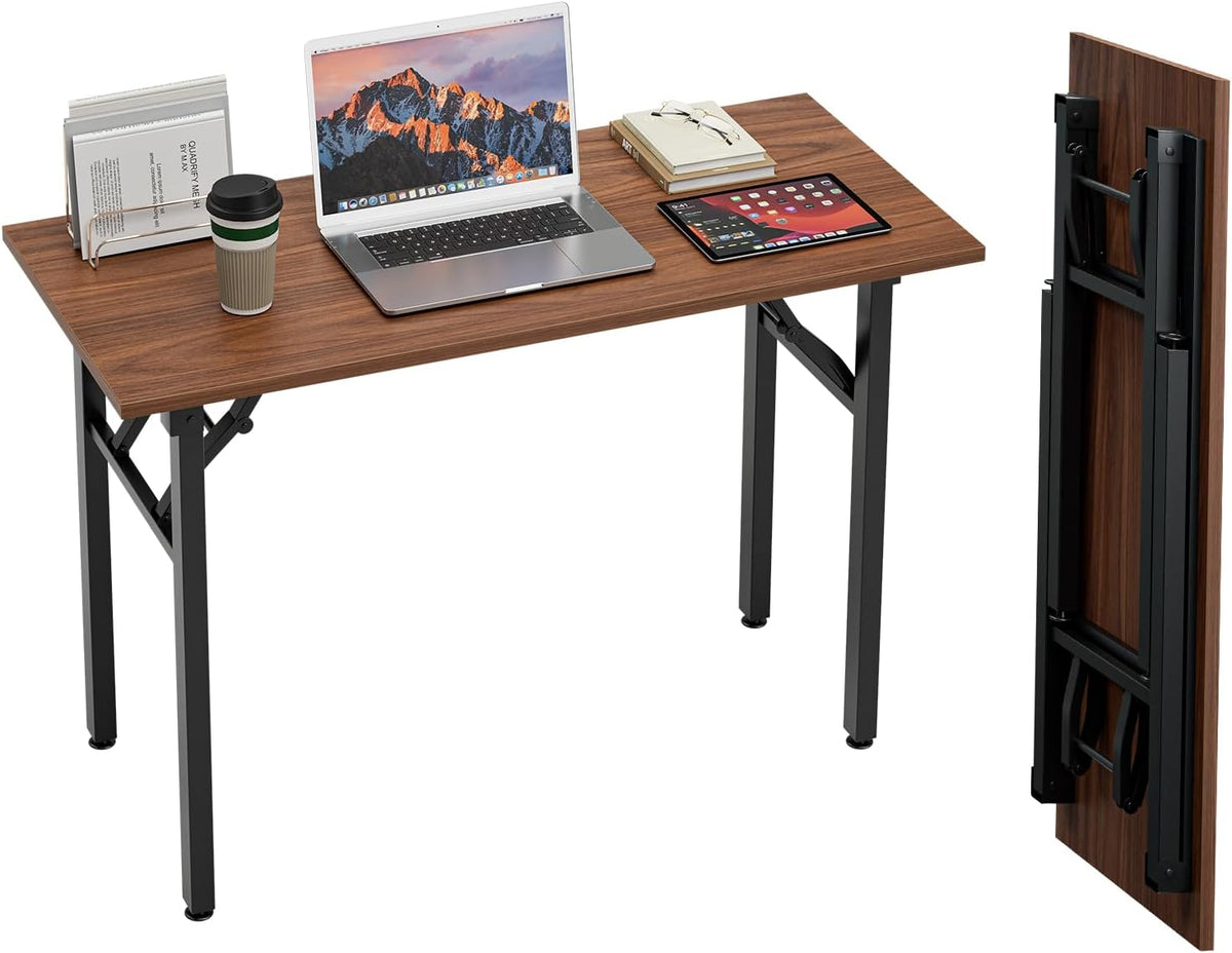 Three-quarter shot of a wood‑grain top desk with laptop, tablet and a folded tabletop panel shown standing at right.