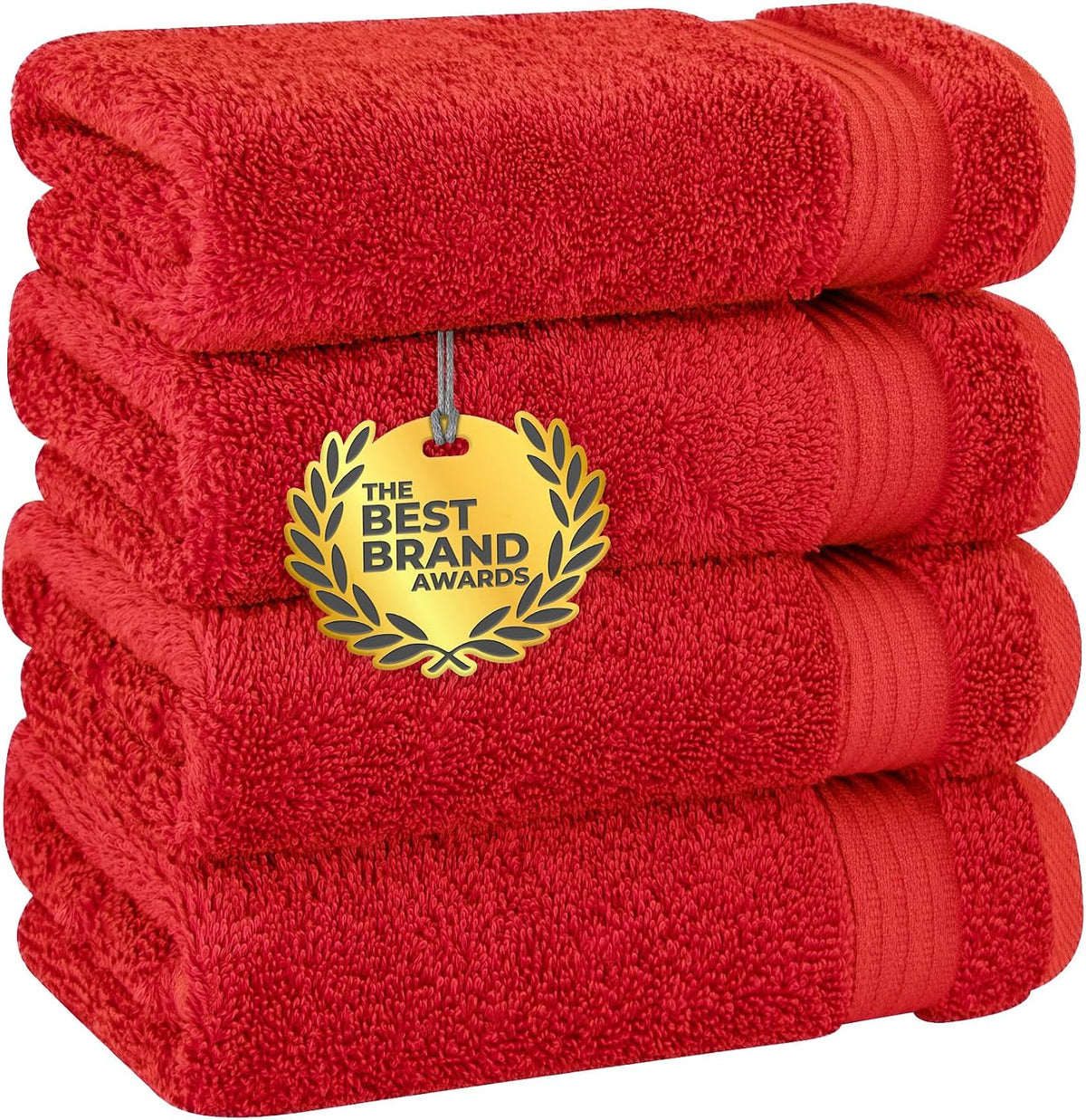 Four bright red towels stacked to highlight dense terry loops and a decorative ribbed border.