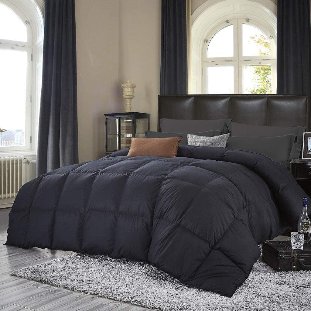 Black down comforter covering a bed beneath arched windows, front perspective showing full coverage