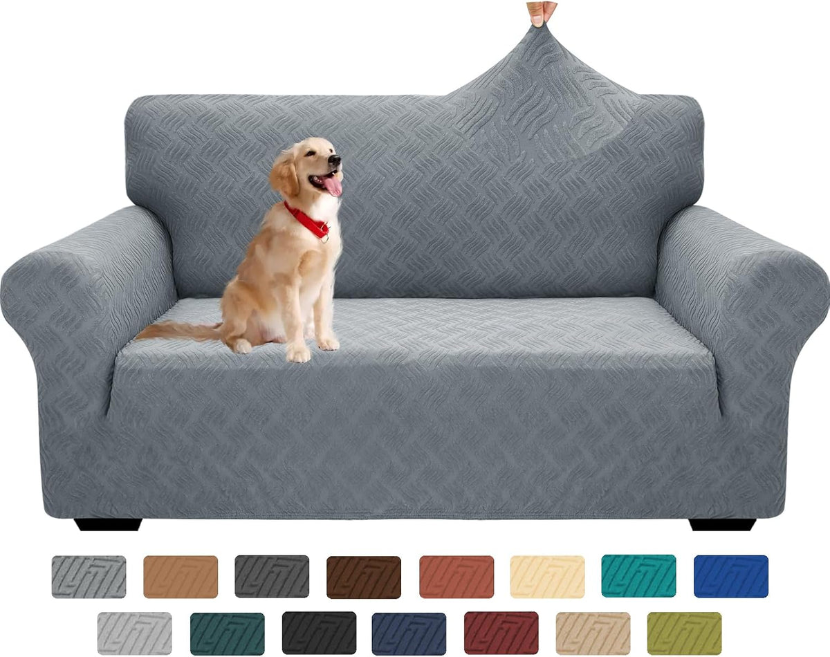 Front view of a three-cushion sofa in light-gray textured slipcover with a golden retriever sitting and a hand lifting