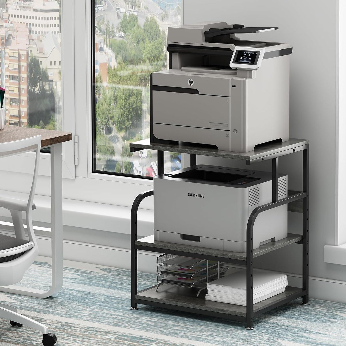 Gray-finished three-tier stand holding two printers with a paper tray and ream stored on the bottom shelf.