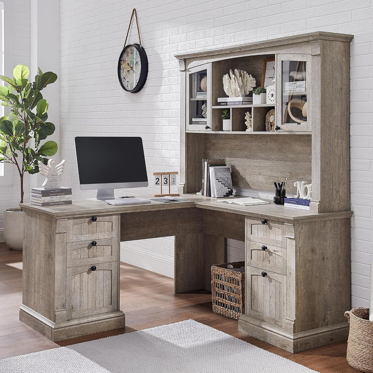 Complete L-shaped desk with matching hutch in light gray wood finish, decorated with books and decor.