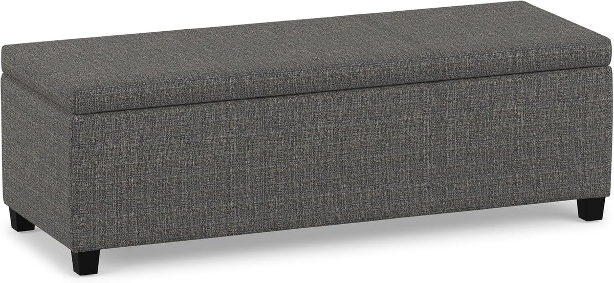 Rectangular slate-grey textured fabric storage ottoman on short black legs, front three-quarter view.