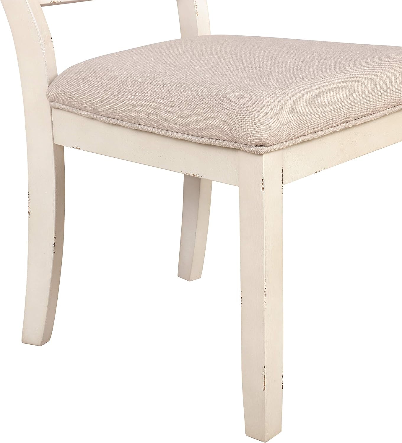 Close-up of a padded beige chair seat and distressed white wooden frame