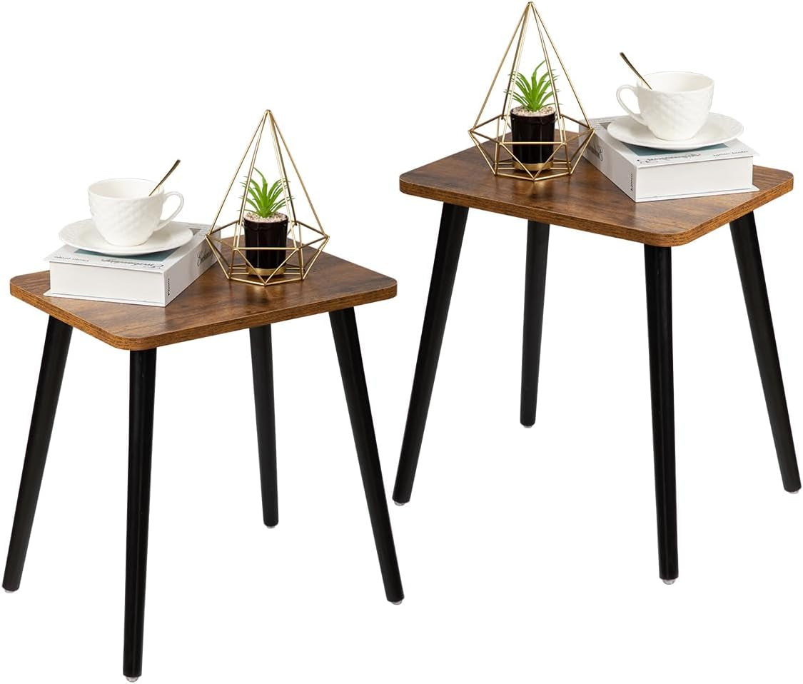 Pair of small square side tables with dark wood tops and black legs, each holding a cup and decor