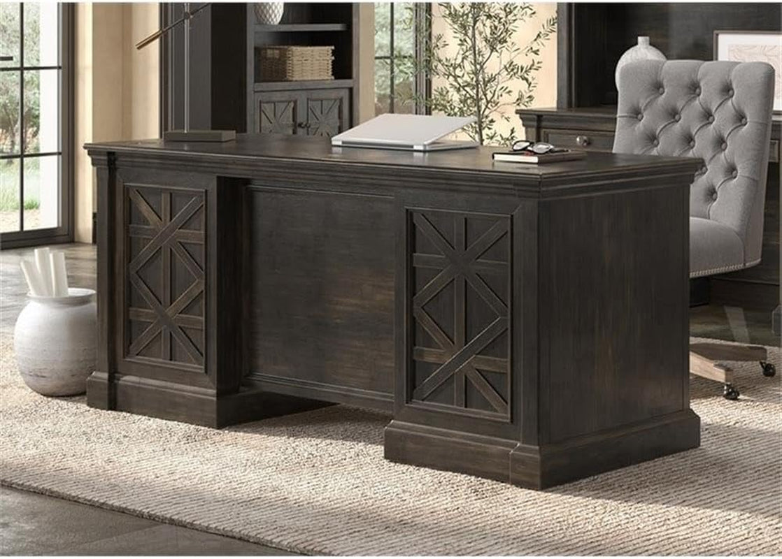 Angled front view of distressed dark brown executive desk showing criss-cross panel detailing on the pedestals