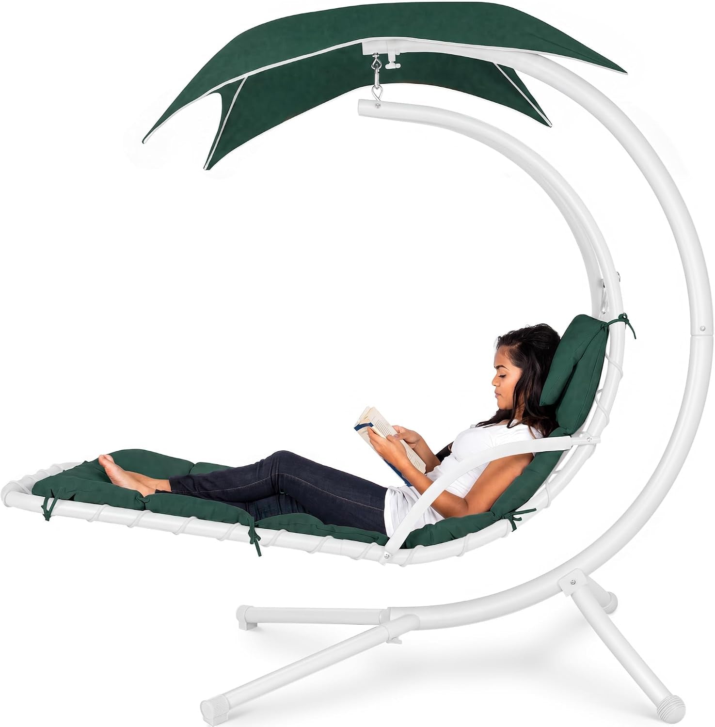 White curved steel hanging chaise with teal cushions and canopy, woman reclining and reading a book