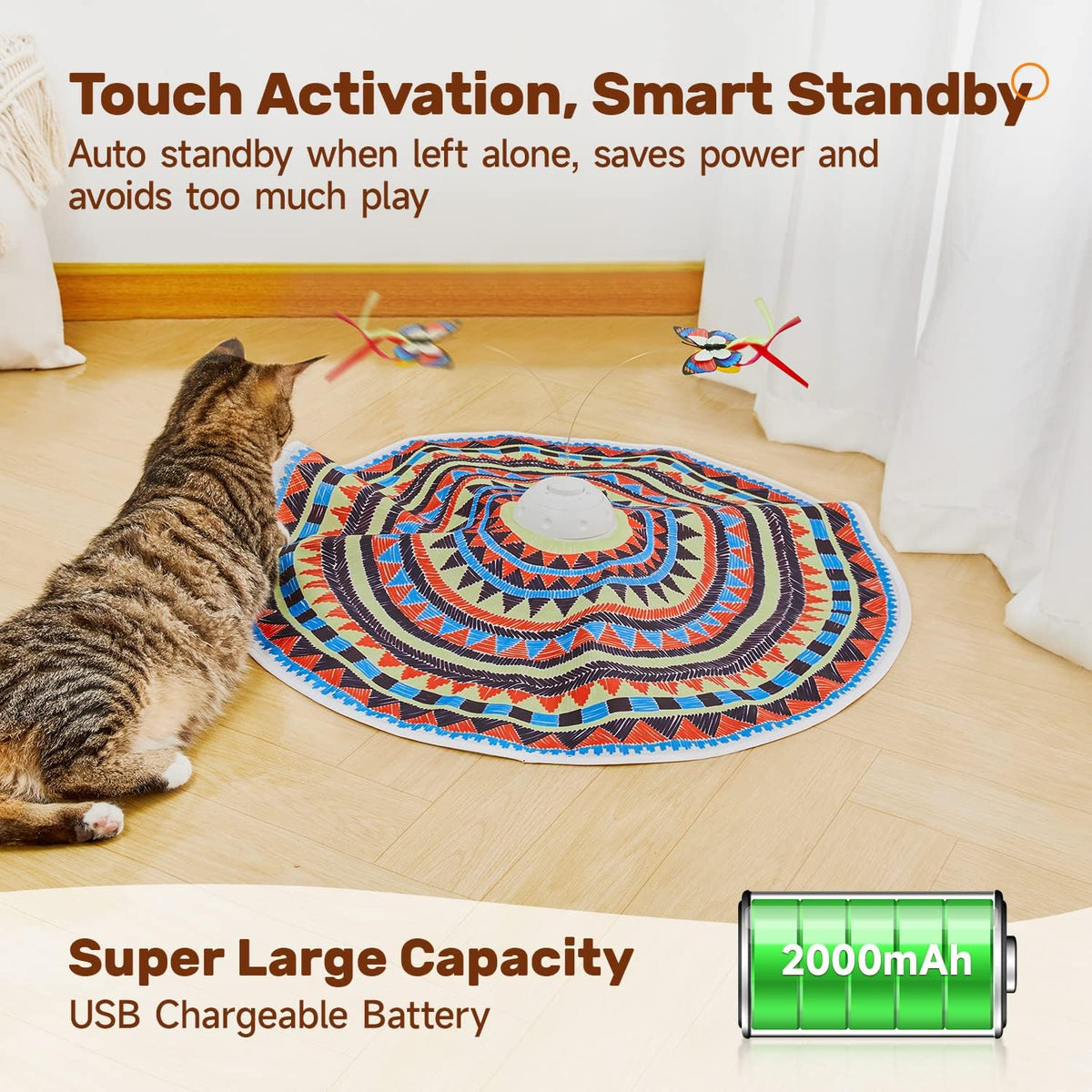 Cat reaching toward a large patterned circular play mat with two butterfly wands attached to a central spinner.