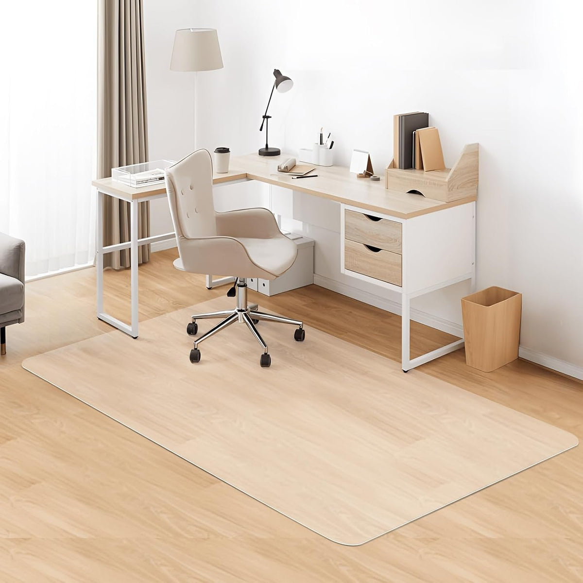 Home office corner with a clear mat covering light wood floor under a beige swivel chair and an L-shaped desk.