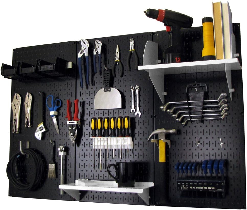 Black metal pegboard mounted on wall displaying hand tools, two white shelves and small storage bins.
