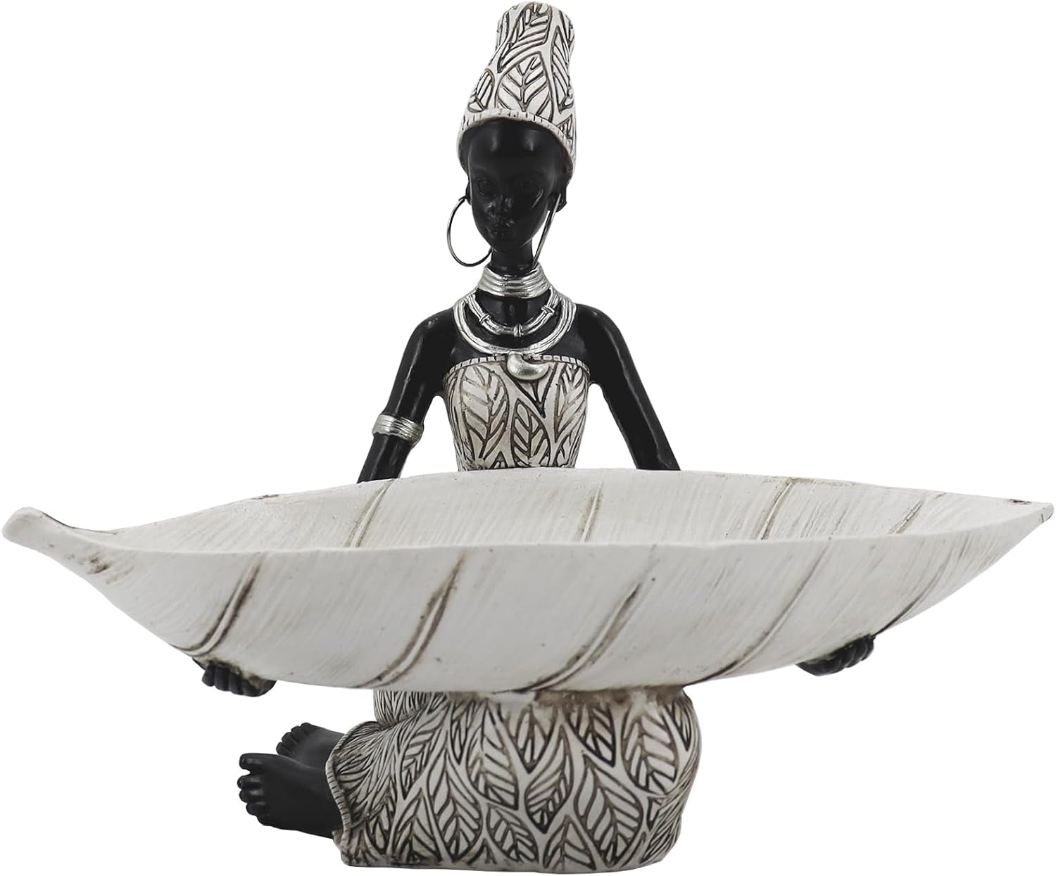 Seated black female figurine holding a shallow leaf-shaped white tray with carved patterns
