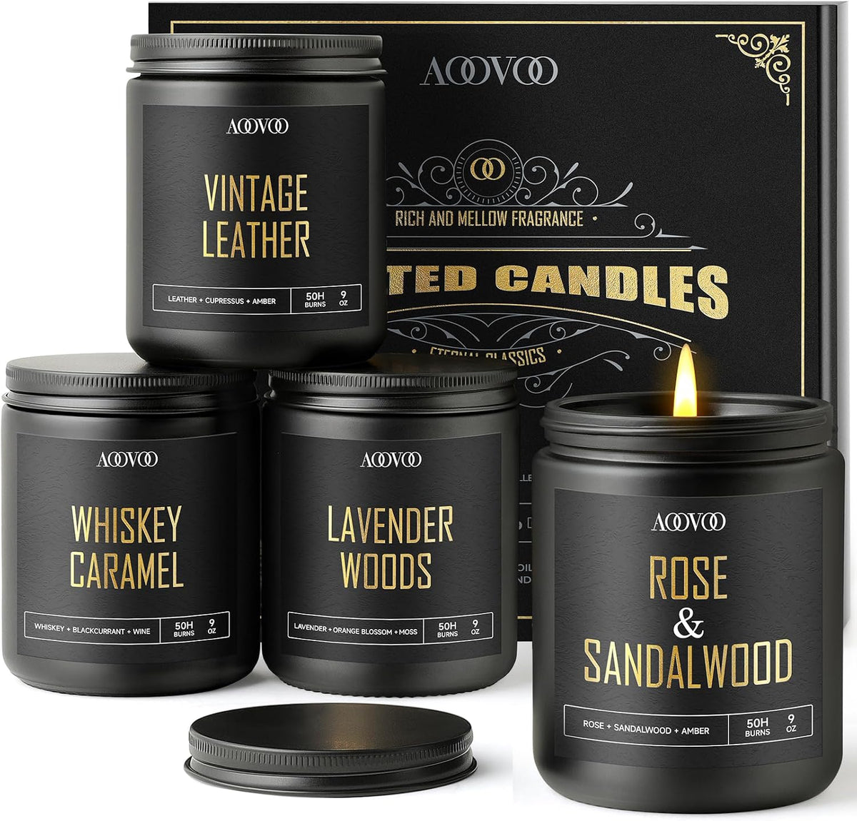 Four black jars arranged in a pyramid in front of a boxed backdrop, one candle lit while others have screw-on lids nearby.