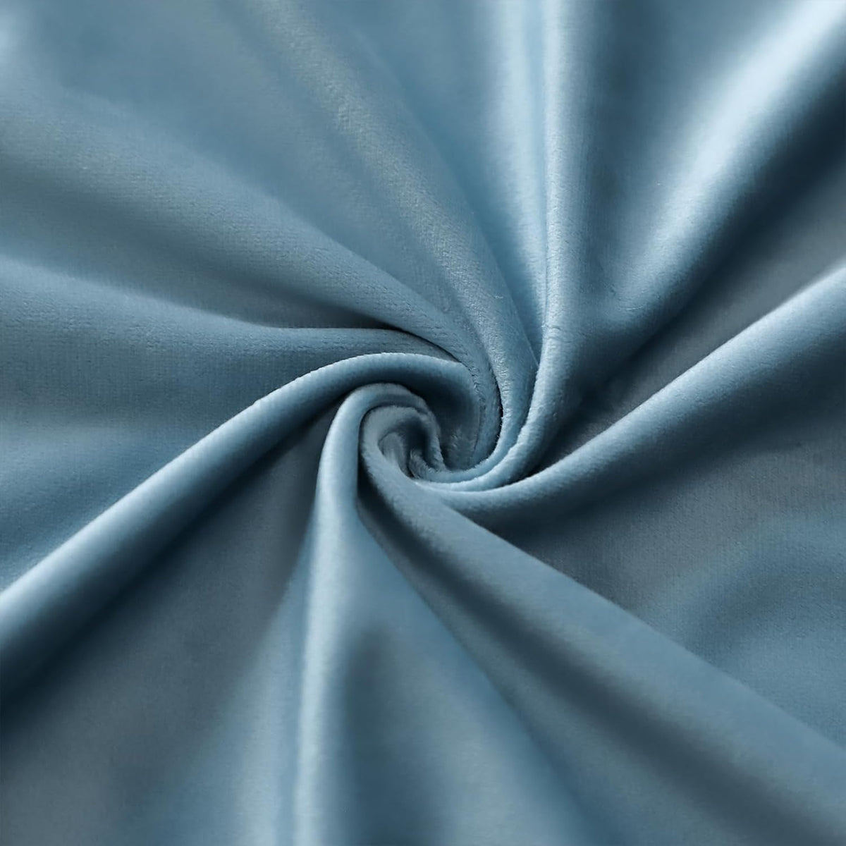 Close-up of light-blue velvet fabric twisted to show smooth, slightly shiny texture